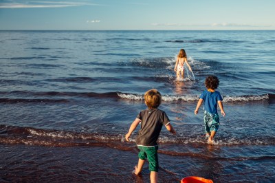 cousins running into the Atlantic ocean waves