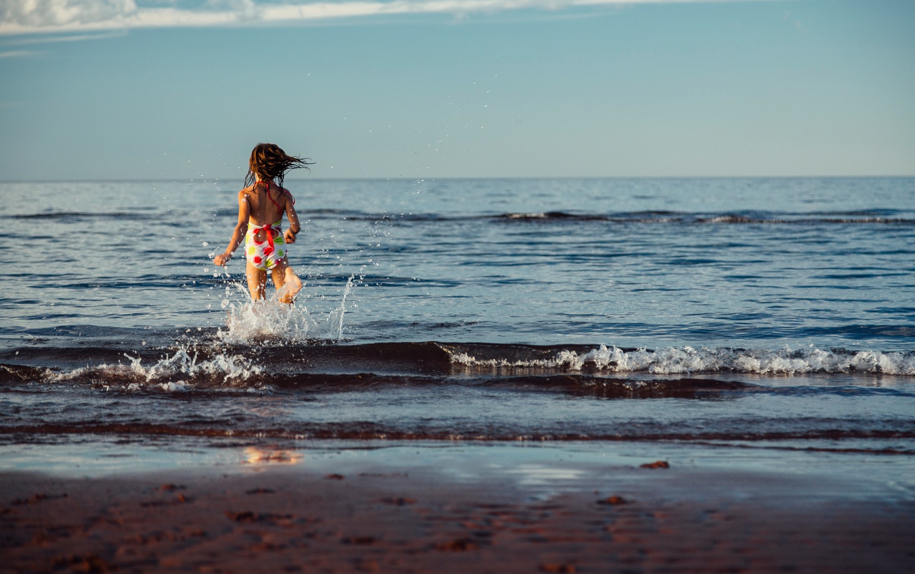 sister running into the ocean