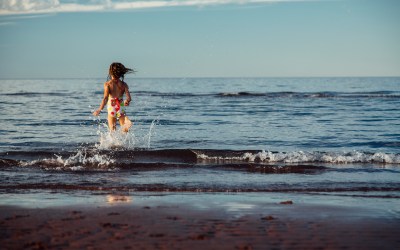 sister running into the ocean