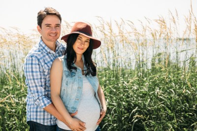 pregnant couple holding belly